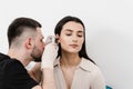 ENT doctor with otoscope. Otoscopy. Otolaryngologist looks through otoscope the ears of woman. Treatment ear pain. Royalty Free Stock Photo