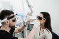 ENT doctor in protective glasses holding surgical laser and doing laser treatment inflammation of the nasal lining Royalty Free Stock Photo