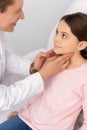 Smiling ent physician touching neck of