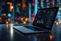 Modern Laptop Displaying Financial Analytics and Stock Market Charts in a City Nightscape Royalty Free Stock Photo