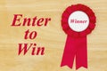 Enter to win message with winner pink ribbon on a wood desk for your customer contest