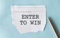 Enter to Win text on paper. Word Enter to win on blue background. Concept Image Royalty Free Stock Photo
