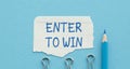 Enter to win text on paper. Word Enter to win on torn paper. Concept Image. Royalty Free Stock Photo