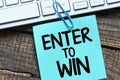 ENTER TO WIN words on a small piece of paper Royalty Free Stock Photo