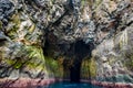 Entering the cave in the ocean under the the mountain Royalty Free Stock Photo