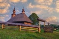 Entering gate to wooden church in Hrabova Roztoka during summer sunrise