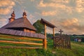 Entering gate to wooden church in Hrabova Roztoka during summer sunrise