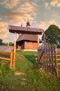 Entering gate to wooden church in Hrabova Roztoka during summer sunrise