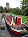 Narrowboat on canal and nearby church Royalty Free Stock Photo