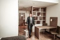 Young businessman entering hotel room with his luggage Royalty Free Stock Photo