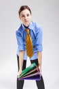 Enterpreneurs Concepts. Caucasian Female In Business Shirt and Tie Holding Batch of Folders As Hard Yoke.Against White