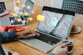 Business woman working with laptop computer with icons on virtual screen on office desk Royalty Free Stock Photo