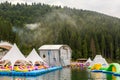 Entertaiment of Voda club on the pond among Carpathian mountains. Rental boats for lake tour