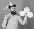 Entertainer with colorful baloons at kids party, international childrens day. Bearded artist with party wistle and paper