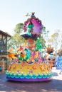 The Little Mermaid in colorful costumes riding on a float participating in DisneyWorld parade