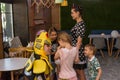 Entertainers playing with happy kids during children protection day