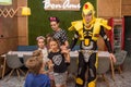 Entertainers playing with happy kids during children protection day inside cafe