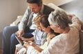 Entertainment for everyone. an elderly couple and their grandchildren sitting together and using digital tablet. Royalty Free Stock Photo