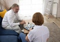 For entertainment and leisure, the family plays chessboard in the living room.