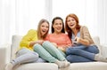 Teenage girls or friends watching tv at home Royalty Free Stock Photo