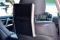 Entertainment system for rear passengers in a car with two monitors mounted on the backs of the front seats for watching TV, Royalty Free Stock Photo