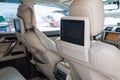 Entertainment system for rear passengers in a car with two monitors mounted on the backs of the front seats for watching TV, Royalty Free Stock Photo