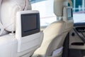 Entertainment system for rear passengers in a car with two monitors mounted on the backs of the front seats for watching TV, Royalty Free Stock Photo