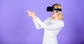 Enthralling interaction virtual reality. Woman head mounted display violet background. Virtual reality shooting gallery Royalty Free Stock Photo