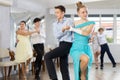 Enthusiastic adolescent girl and boy dancing in pair in dance studio Royalty Free Stock Photo