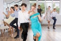 Enthusiastic adolescent girl and boy dancing in pair in dance studio Royalty Free Stock Photo