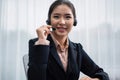 Enthusiastic asian call center with headset on her workplace portrait. Royalty Free Stock Photo