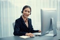 Enthusiastic asian call center with headset on her workplace portrait. Royalty Free Stock Photo