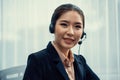 Enthusiastic asian call center with headset on her workplace portrait. Royalty Free Stock Photo