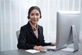 Enthusiastic asian call center with headset on her workplace portrait. Royalty Free Stock Photo