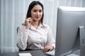 Enthusiastic asian call center with headset on her workplace portrait. Royalty Free Stock Photo