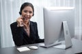 Enthusiastic asian call center with headset on her workplace portrait. Royalty Free Stock Photo