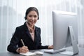 Enthusiastic asian call center with headset on her workplace portrait. Royalty Free Stock Photo