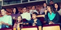 Enthusiastic audience eating popcorn and watching a movie