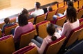 Enthusiastic audience eating popcorn and watching a movie