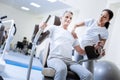 Enthusiastic baby boomer using weight machine in a rehabilitation center