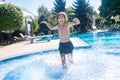 Enthusiastic boy running in the outdoor pool