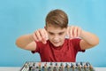 An enthusiastic child is about to tune a music mixing console Royalty Free Stock Photo