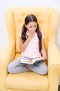 Enthusiastic about exciting story. Reading hobby. Girl child sit yellow armchair read book. Kid cute bookworm. Girl kid