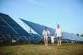 Enthusiastic father showing potential of alternative energy. Contemporary family looking at new solar station they