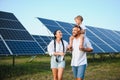 Enthusiastic father showing potential of alternative energy. Contemporary family looking at new solar station they