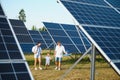 Enthusiastic father showing potential of alternative energy. Contemporary family looking at new solar station they