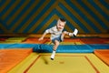 Enthusiastic boy jumping on a square trampoline in entertainment center