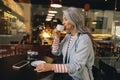 Modern Asian lady relaxing at street cafe Royalty Free Stock Photo