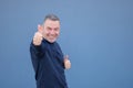 Enthusiastic middle aged man giving a thumbs up gesture with a beaming smile Royalty Free Stock Photo