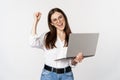 Enthusiastic office woman, businesswoman holding laptop and shouting with joy, celebrating and rejoicing, standing over Royalty Free Stock Photo